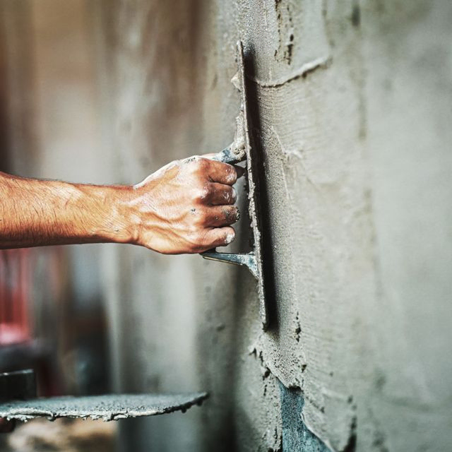 closeup-hand-worker-plastering-cement-wall-building-house
